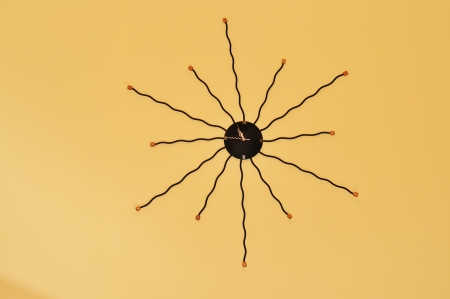 Sun shaped watch on a wall