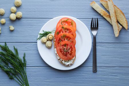 Sandwich with tomatoes, cheese, dill, pepper and mushrooms for breakfastの写真素材