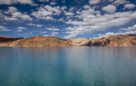 Mountains and Pangong tso (Lake). It is huge lake in Ladakh, with snow peaks and blue sky in background, it extends from India to Tibet. Leh, Ladakh, Jammu and Kashmir, Indiaの写真素材