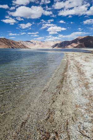Mountains and Pangong tso (Lake). It is huge lake in Ladakh, with snow peaks and blue sky in background, it extends from India to Tibet. Leh, Ladakh, Jammu and Kashmir, Indiaの写真素材