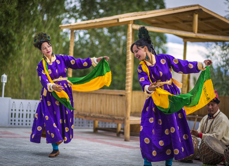 Artists in traditional tibetan costumes performing folk song in Leh, Indiaのeditorial素材