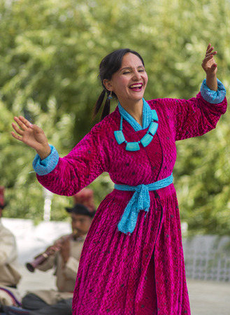 Artists in traditional tibetan costumes performing folk song. in Leh, India.のeditorial素材