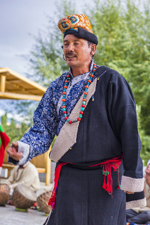 Artists in traditional tibetan costumes performing folk song. in Leh, India.のeditorial素材