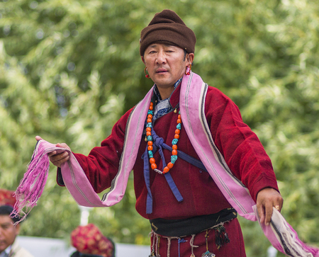 Artists in traditional tibetan costumes performing folk song. in Leh, India.のeditorial素材