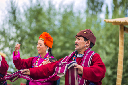 Artists in traditional tibetan costumes performing folk song. in Leh, India.のeditorial素材