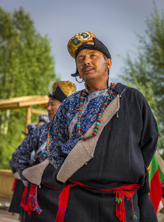 Artists in traditional tibetan costumes performing folk song  in Leh, India.のeditorial素材