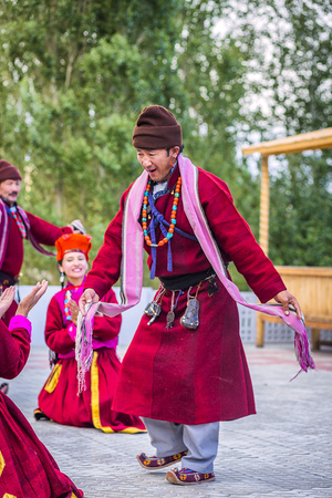 Artists in traditional tibetan costumes performing folk song  in Leh, India.のeditorial素材