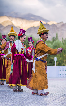 Artists in traditional tibetan costumes performing folk song  in Leh, India.のeditorial素材