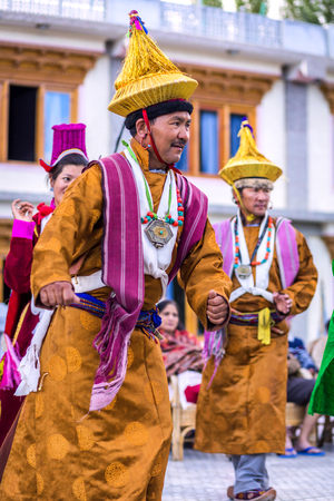 Artists in traditional tibetan costumes performing folk song  in Leh, India.のeditorial素材