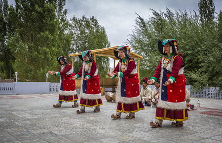 Artists in traditional tibetan costumes performing folk song  in Leh, India.のeditorial素材