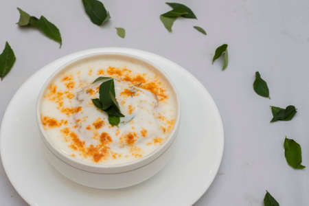 Dahi Vada or Dahi Bhalla is Popular Indian street food.Sweet, spicy and Tasty served with chutney. closeup focus.の写真素材