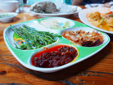 Eating raw oysters with lemon, garlic, herbs and chilli burn の写真素材