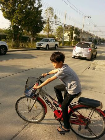 The boy very happy when he riding a bicycleの素材