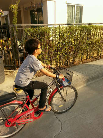 The boy very happy when he riding a bicycleの素材