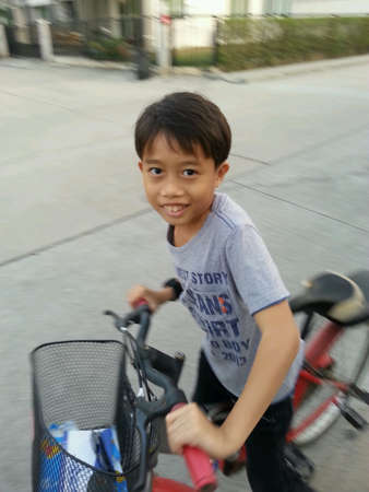 The boy very happy when he riding a bicycleの素材
