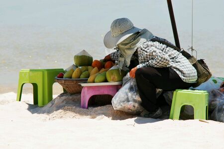 Woman sell fruits on the beach at Huahin Thailandの素材