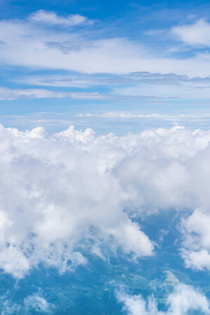 white cloud ,clear blue sky and green earth view from airplaneの写真素材