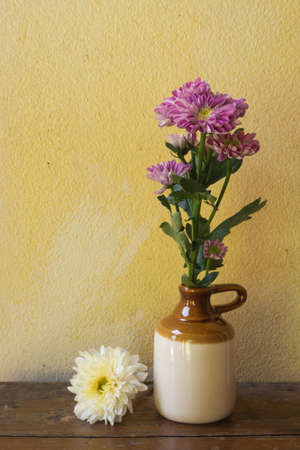 Still life with flower on wooden table over grunge backgroundの写真素材