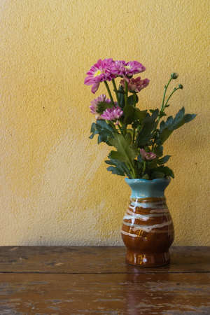 Still life with flower on wooden table over grunge backgroundの写真素材