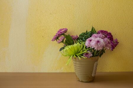 Still life with flower on wooden table and grunge backgroundの写真素材