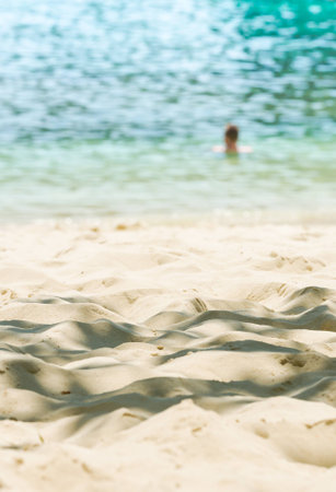 tourist swimming at the beach on background blurの写真素材