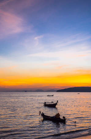 silhouette, sunset and boat on the beachの写真素材