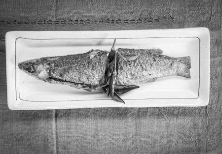 fried mullet fishs  on black and  whiteの写真素材