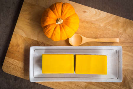 pumpkin cake and twin doll on wooden tableの写真素材