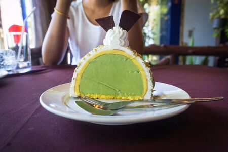green tea cake and ice cream on white plateの写真素材