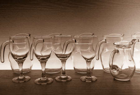 still life with glassware collection on wooden background