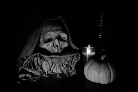 Still life with skull and pumpkin on black backgroundの写真素材