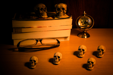 Still life with group of human skull and time to read a bookの写真素材
