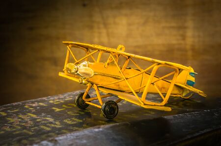 Still life with old model fighter plane on bullet box