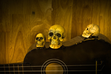 Still life with skull and old ukulele on wooden backgroundの写真素材