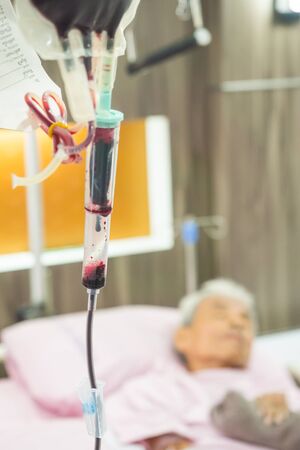 Older patients with blood on his hospital bed.の写真素材