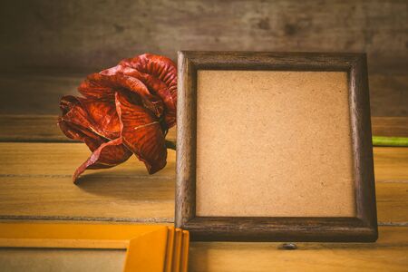 Wooden frame and flower on wooden background,Still life of love