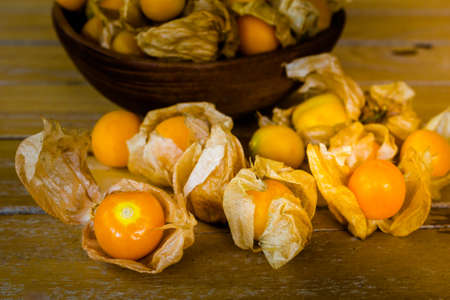 Organic fresh gooseberries on old wooden backgroundの写真素材