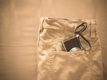 Vintage chino pants and camera for men on fabric backgroundの写真素材