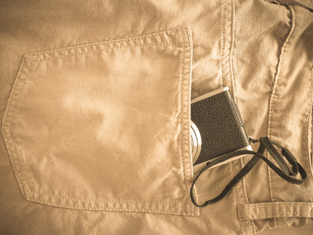 Vintage chino pants and camera for men on fabric backgroundの写真素材