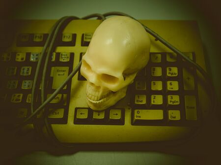 Still life with skull on keyboard , Concept work hardの写真素材