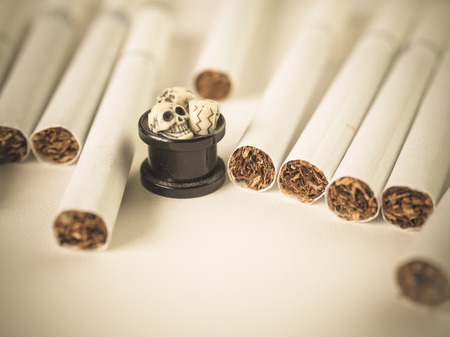 Cigarette and skull on white background, Concept for healthyの写真素材