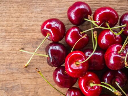 Fresh organic cherry group on wooden background
