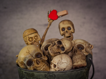 Still life with human skull in bucket on abstract background ,Love conceptの写真素材