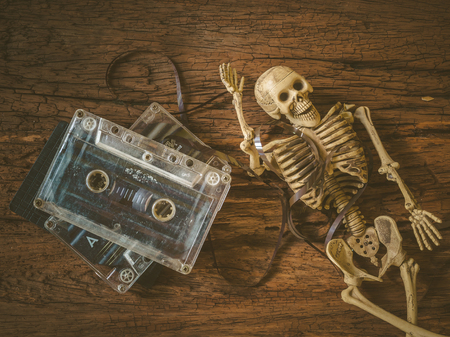Vintage old cassette tape and skull on wooden backgroundの写真素材