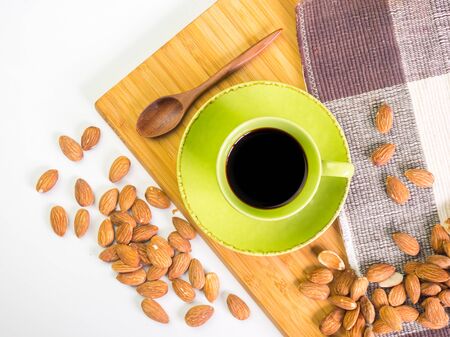 Black hot fresh coffee and organic almonds on wooden backgroundの写真素材
