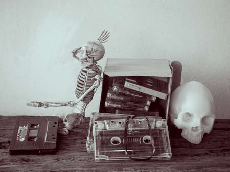 Vintage old cassette tape and skull on wooden backgroundの写真素材