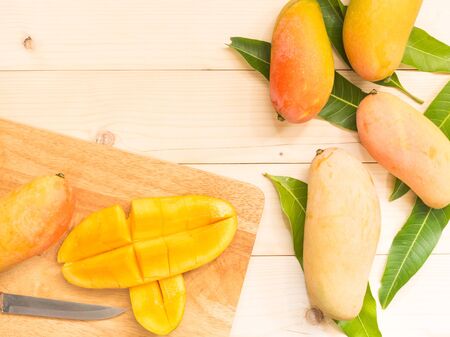 Fresh organic mangos sliced on wooden backgroundの写真素材