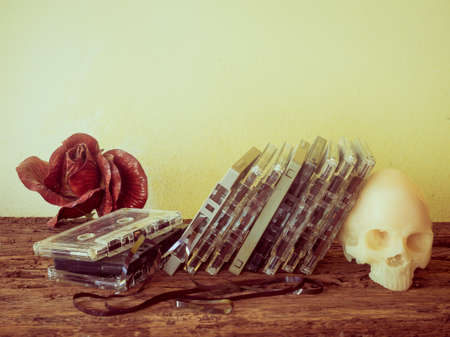 Vintage old cassette tape and skull on wooden backgroundの写真素材