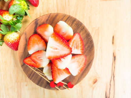 Fresh slice organic strawberries on wooden background, Selective focusの写真素材