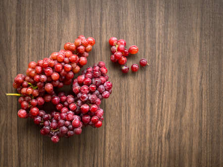 Still life with group of fresh grapes on vintage wooden background